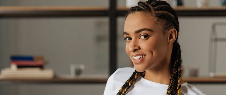 A woman with braids showing her smile