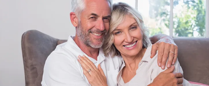 A picture of a happy old couple on a couch